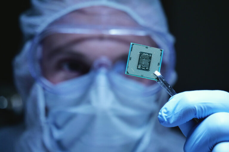Researcher holding a microchip.